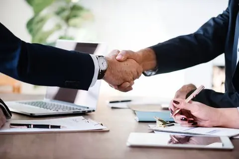 A business deal concluded with a congratulatory handshake